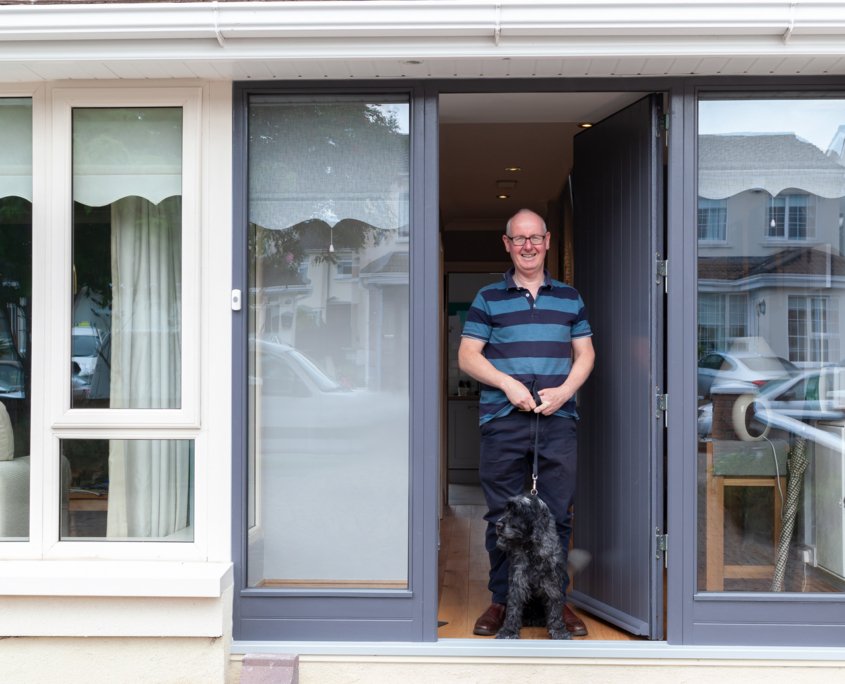 A happy Churchfield customer standing ourside his Deep Retrofit house.