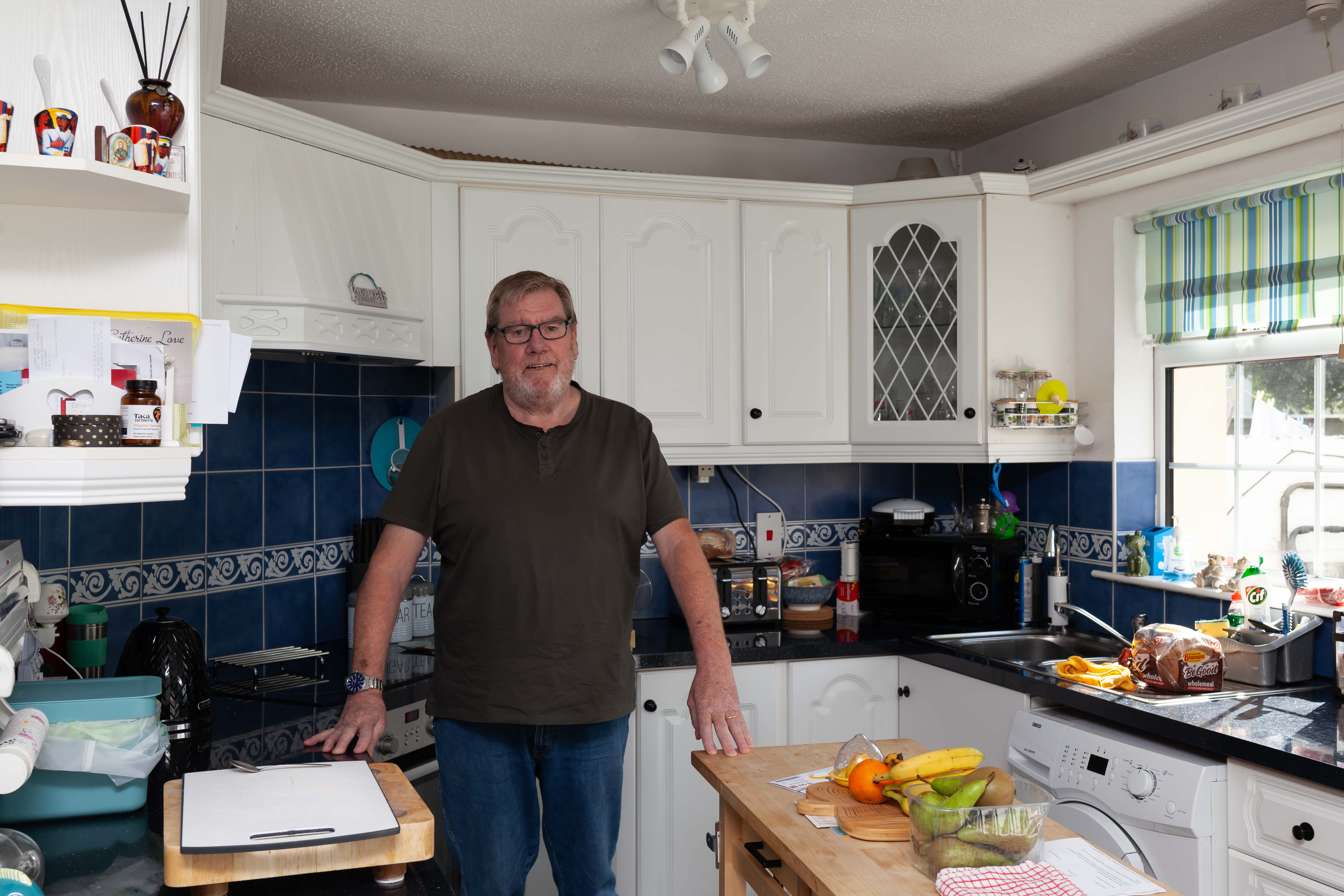 Man standing in kitchen with external wall insulation